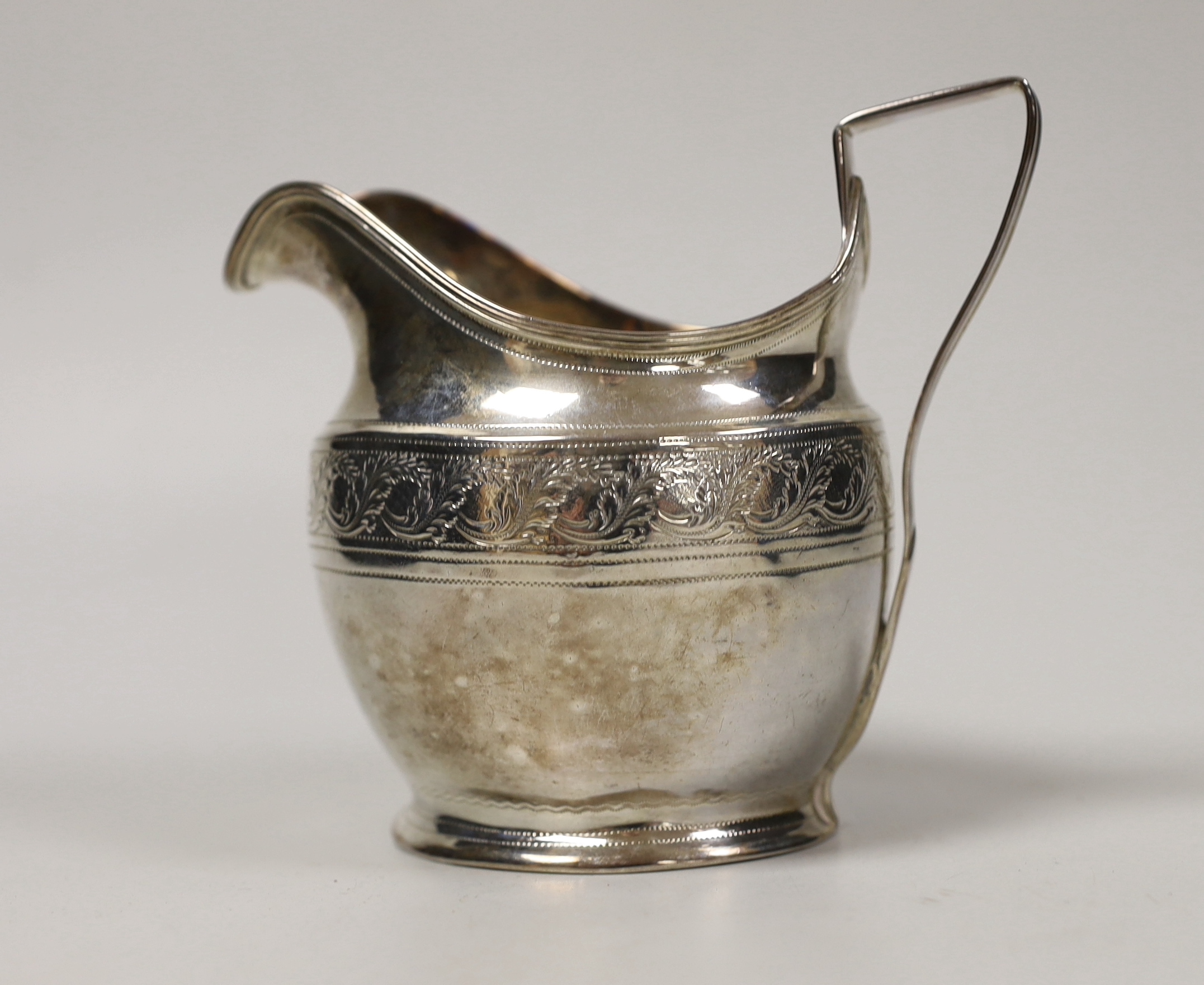 A George III engraved silver helmet shaped cream jug, Andrew Fogelburg, London, 1801, height 10.2cm, 4.7oz.